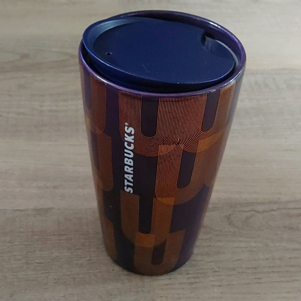 Starbucks ceramic travel mug 12oz. Decorated in purple with art deco gold design
